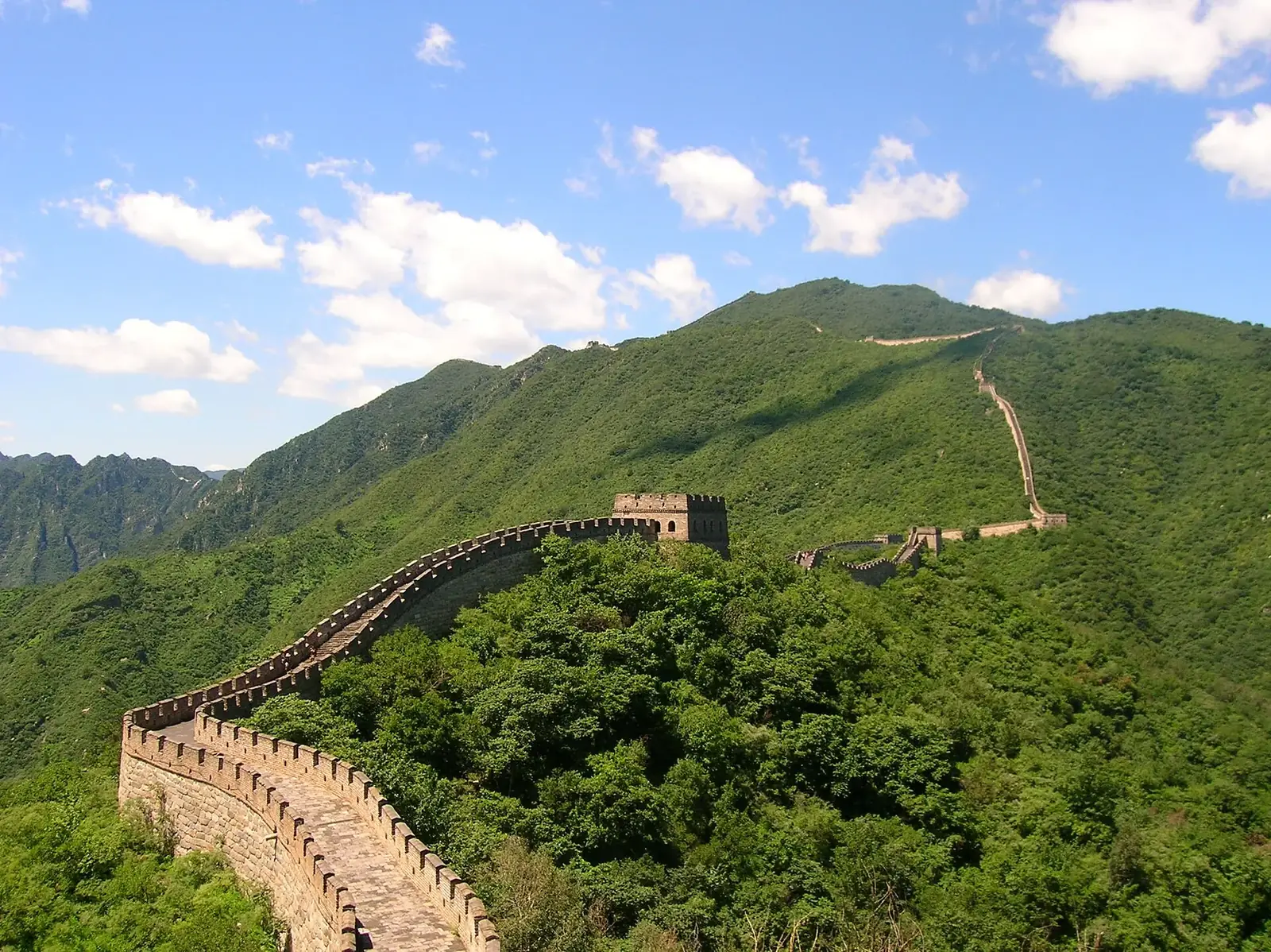 The Great Wall winding across misty mountains, near Mutianyu.