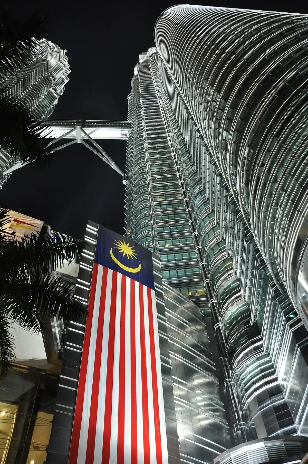 Petronas Twin Towers at night, Kuala Lumpur city skyline illuminated.